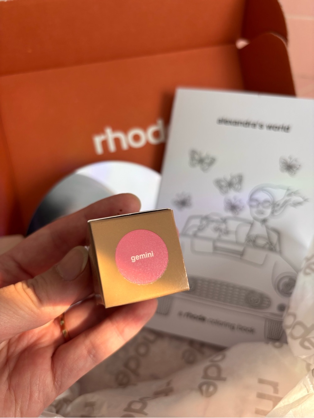 Rhode Pocket Pearl Blush in Gemini by Alexandra Leclerc and coloring book